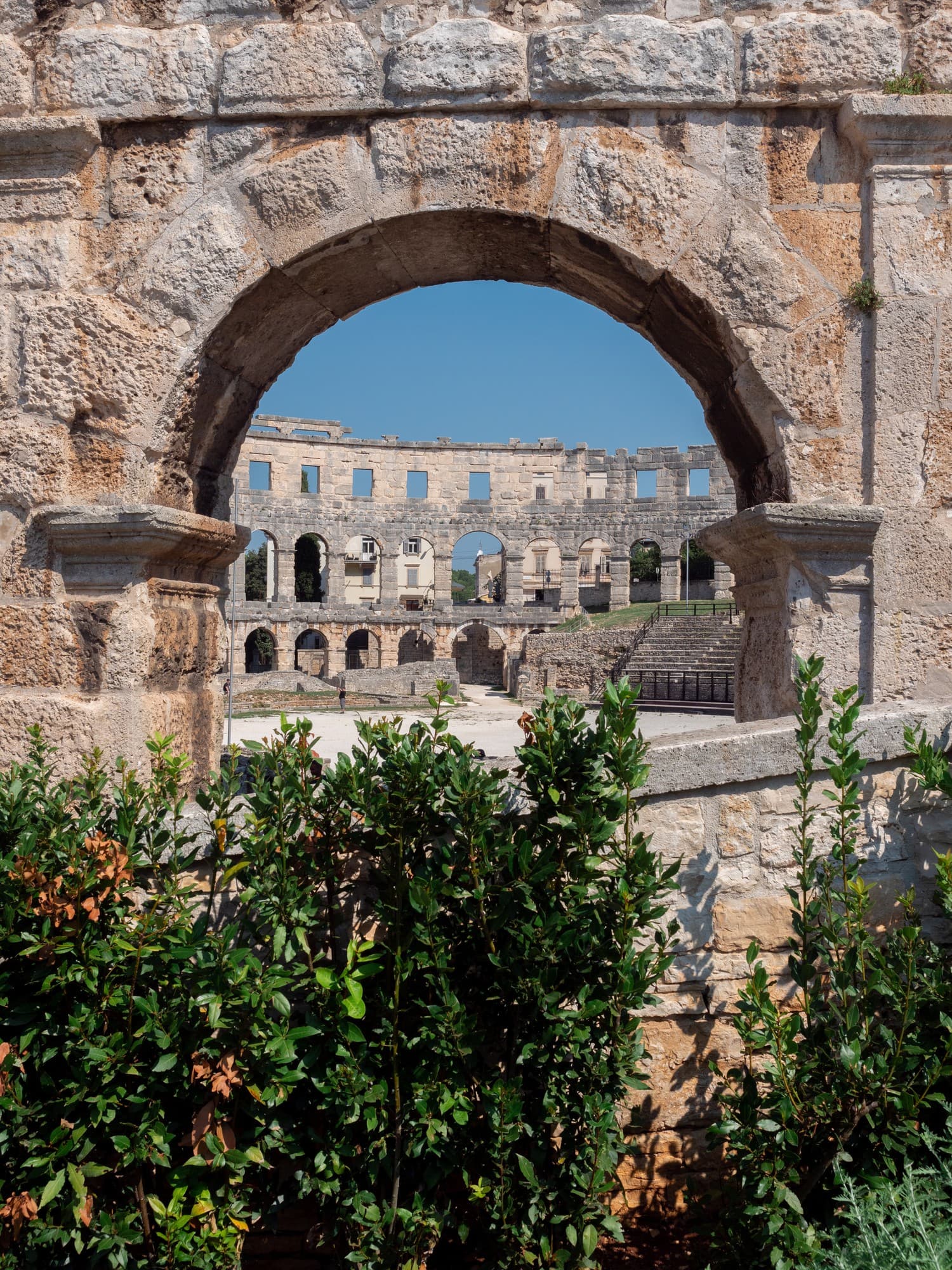 Pula arena seen through one of its stone arches